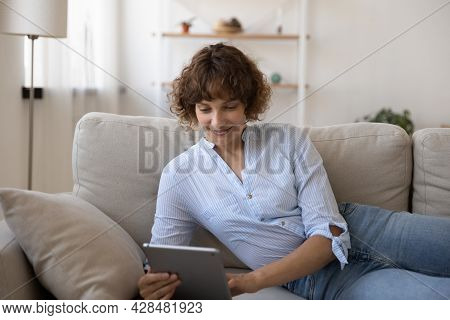 Happy Young 35s Woman Using Digital Computer Tablet.