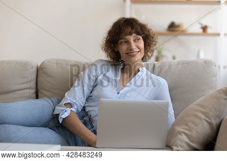 Dreamy Young 35s Woman Using Computer At Home.