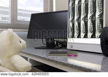 An Adorable Stuffed Bear Looking At The Mri Scan Of Lumbar Spines On The Film Box In The Medical Off