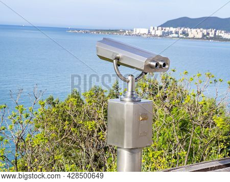 Metal Gray Stationary Binoculars On The Observation Deck With Views Of The Sea, Mountains And The To
