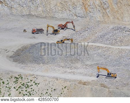 Many Industrial Excavators, Earthmoving Machines Extract Cement And Marl Rock In The Mountains Of No