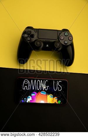 Tula, Russia - April 08, 2021: Among Us Logo On Iphone Display And Ps Gamepad