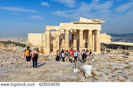 Athens - May 8, 2018: People Visit Famous Acropolis Of Athens, Greece. View Of Ancient Greek Propyla