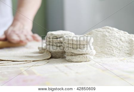 Woman with a rolling for Karelian pies