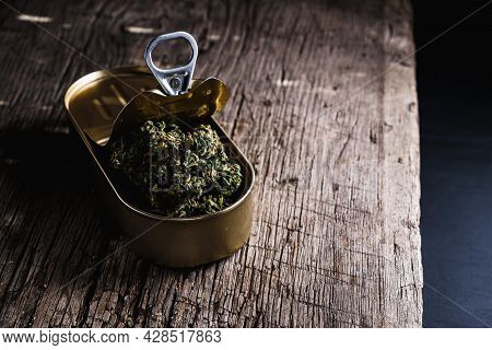 Cannabis In A Open Tin Can. On Old Wooden Background. Rustic. Horizontal Orintation