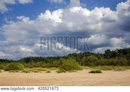Cumulus Clouds Over Wild Sandy Coast Of The Baltic Sea In Vecaki, Latvia