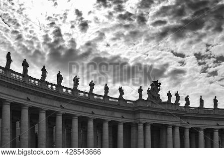 Details Of The Entablature With Statues Of Religious Saints On The Colonnades Of St. Peter's Basilic