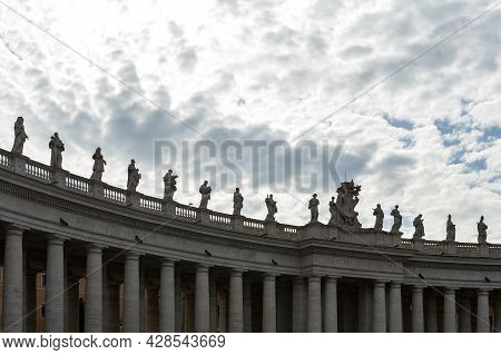 Details Of The Entablature With Statues Of Religious Saints On The Colonnades Of St. Peter's Basilic