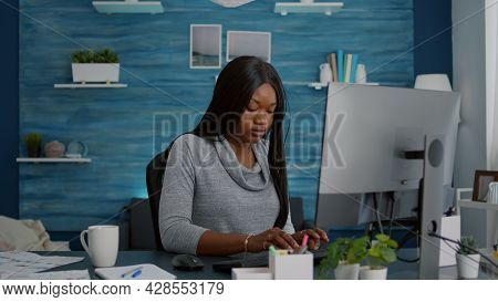 Black Student Sitting At Desk Table Start Working At Online Homework Using Computer Typing Informati