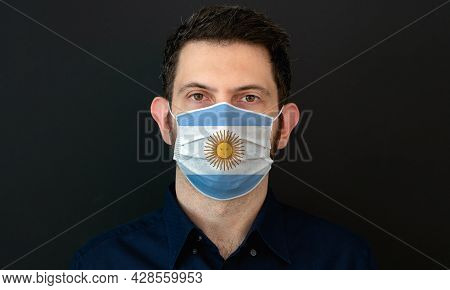 Man Wearing Argentinian Flag Protective Medical Face Mask. He Looks Worried And Concerned. Coronavir