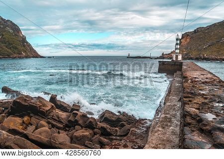A Small Beacon At A Stone Pier In Pasajes San Pedro, Gipuzkoa, Spain