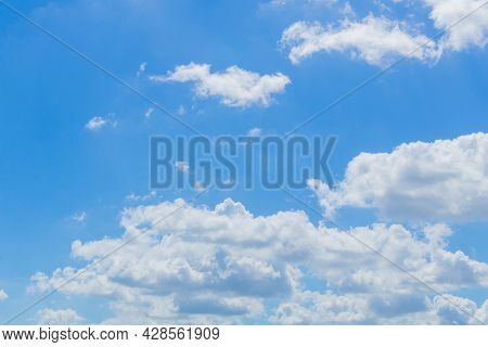 Numerous White Clouds Were Floating In The Sky From One Direction To Another On A Clear Summer Day.