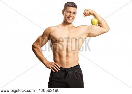 Young shirtless musuclar man flexing arm muscle and holding an apple isolated on white background