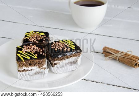 Three Chocolate Pies On A White, Wooden Table. Tea Party With Chocolod Cake. A Mug Of Tea, Cinnamon 