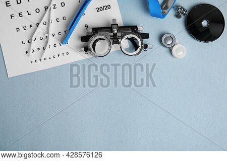 Different Ophthalmologist Tools On Grey Background, Flat Lay. Space For Text