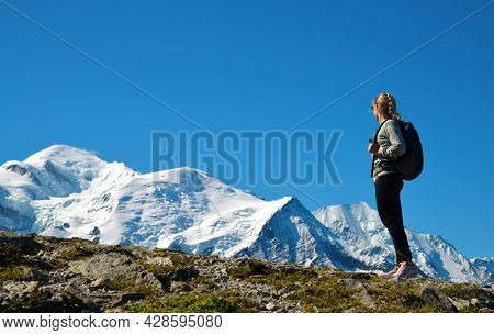 Hiker looking at the Mount Blanc from the summit of Le Brevent. French Alps, Chamonix, France.