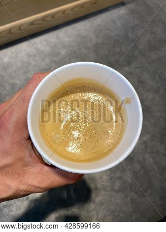 Freddo Espresso Take Away Coffee Holding In Hand. Ready To Drink.