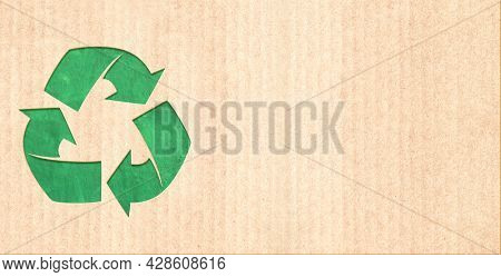 Arrows recycle symbol on striped cardboard texture. Horizontal or vertical banner with eco paper texture. Paper cardboard background. Recycled carton material. Copy space for text. Mock up template