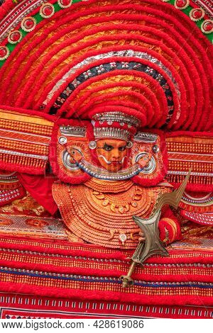 Payyanur, India - December 3, 2019: Portrait of an unidentified Theyyam dancer during temple festival in Payyanur, Kerala, India. Theyyam is a popular ritual form of worship in Kerala, India