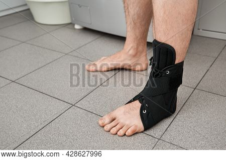 The Male Leg Is Fixed In A Medical Bandage. Ankle Fracture Or Sprain. Lacing And Tight Fit Of The Fo