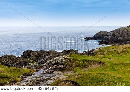 Rugged Landscape At Malin Head, County Donegal, Ireland. Rough Beach With Cliffs, Green Rocky Land W