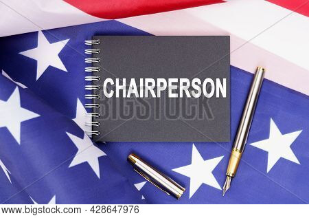 American Concept. The Us Flag Has A Pen And A Notebook With The Inscription - Chairperson