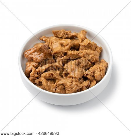Bowl with raw Asian Seitan, wheat gluten, close up isolated on white background
