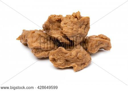 Heap of raw Asian Seitan, wheat gluten, close up isolated on white background