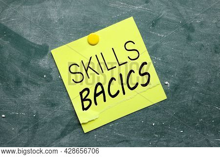 Skills Bacics. Text On Yellow Sticker Pinned To Chalkboard