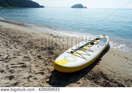 Empty Seaside Landscape Sea Sand Beach With Supboard On Coast Calm Wave Water Surface
