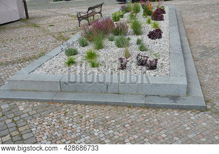 Delivery Of Gray River Pebbles Like Mulch To Flower Beds In The Garden Using A Wheelbarow From The B