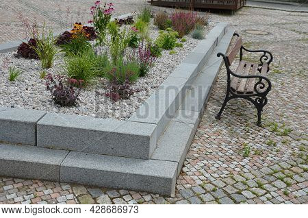 Delivery Of Gray River Pebbles Like Mulch To Flower Beds In The Garden Using A Wheelbarow From The B