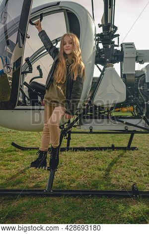 Cute Preteen Girl Standing On Footboard Of Open Helicopter