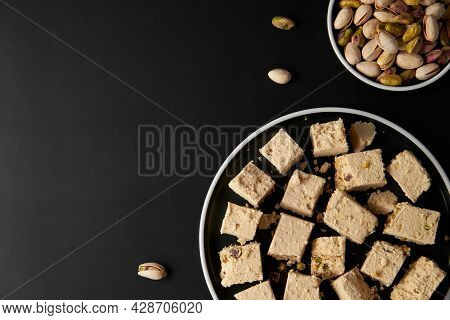 Organic Halva With Pistachios On Black Background. Traditional Middle Eastern Sweets. Jewish, turkis