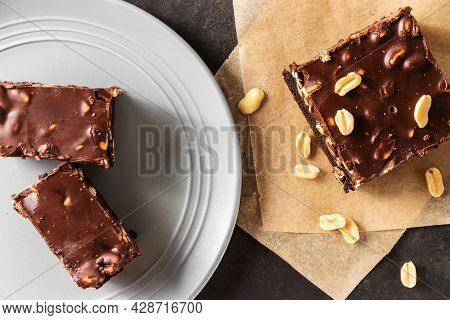 Brownie With Nuts, In A Gray Plate Top View On A Gray Background