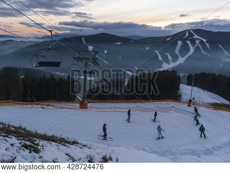 Bukovel, Ukraine - December, 2020: People Are Descending By The Slope In Bukovel Ski Resort. Bukovel