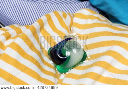 Detergent Pods A Means For Washing And Removing Stains Lies On A Pile Of Laundry. The Concept Of Cle