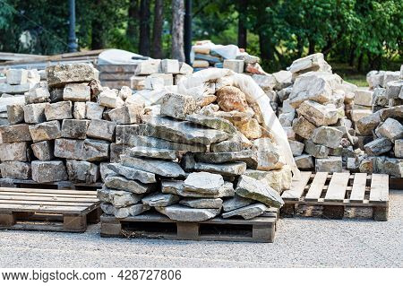 Flat Finishing Stones Are Laid On Wooden Pallets. Reconstruction Of The Old Building.