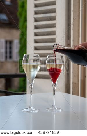Drinking Of Kir Royal,  French Aperitif Cocktail Made  From Creme De Cassis Topped With Champagne, T