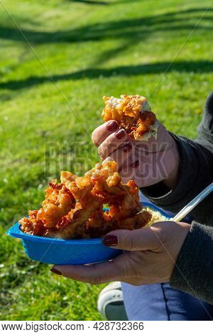Eating Of Diep-fried Cod Fish Pieces Served With Remoulade Sauce