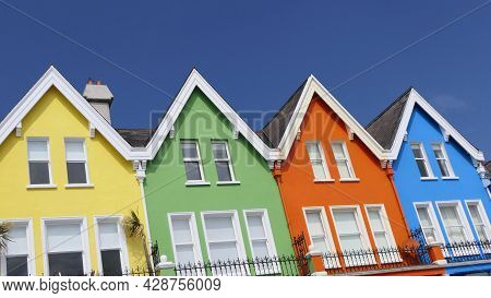Aerial Video Of Yellow Red Blue Green Orange Painted Houses By The Sea Whitehead N. Ireland