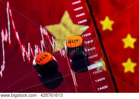 Dices With The Words Sell Buy On The Edges. On Background The Chart Of The Fall Of The Stock Index O