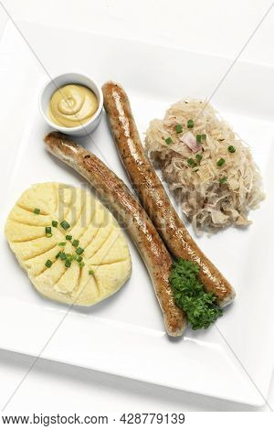 German Thuringer Sausage With Mashed Potato And Sauerkraut Meal On White Plate