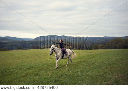 Girl With Horse. The Girl Horseback Riding In Bautiful Landscape. Girl In The Saddle On Horse