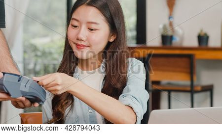Young Asian Freelance Women Pay Contactless Credit Card At Coffee Shop. Asian Happy Men Barista Wait