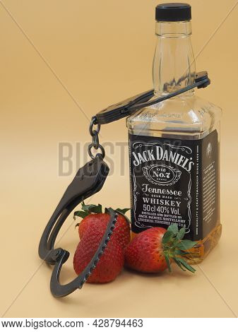 Kirov, Russia-04.25.2021: Classic Black Jack Daniel's Volume Of 50 Cl. With A Strawberry And Handcuf