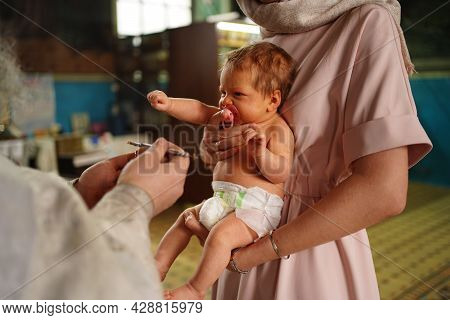 Baby Girl In The Church During Baptism. The Rite Of Chrismation.