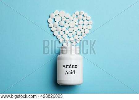 Plastic Bottle With Amino Acid Complex And Pills On Light Blue Background, Flat Lay