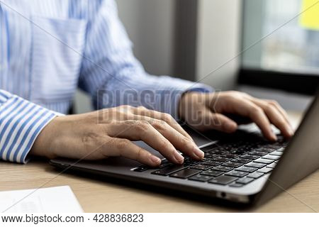 Hands Of Businesswoman Typing On A Laptop Keyboard, She Is Using A Messaging Program To Talk To A Bu