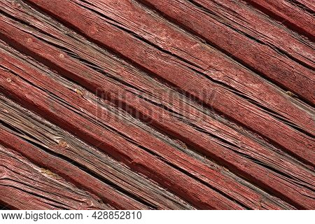 Background Of Falun Red Logs. Diagonal Wooden Backdrop